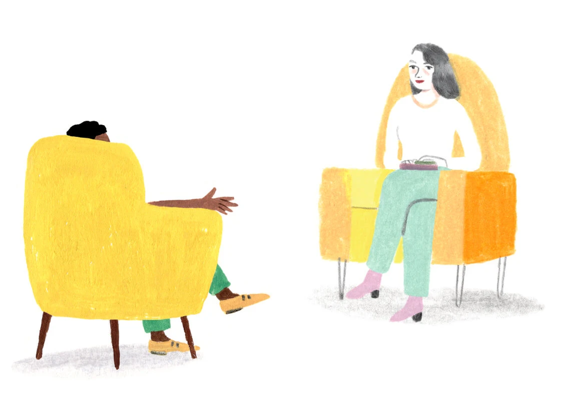 A Monarch by SimplePractice illustration of a woman with gray hair wearing a white shirt, green pants, and pink shoes sitting in an orange chair facing a person with green pants and orange shoes sitting in a yellow chair. 