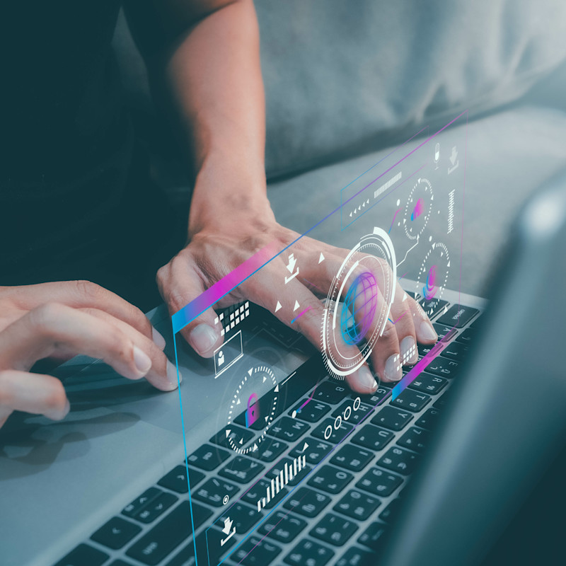 Man working on laptop. Digital visual overlay represents a cyber security theme.