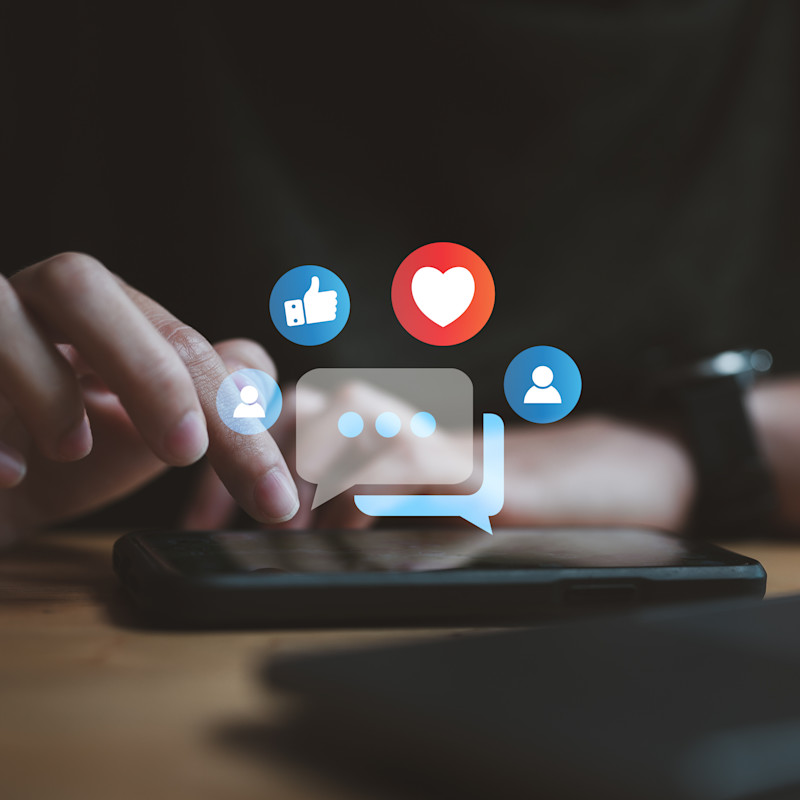 Person browsing and interacting with a social media platform on their mobile phone.