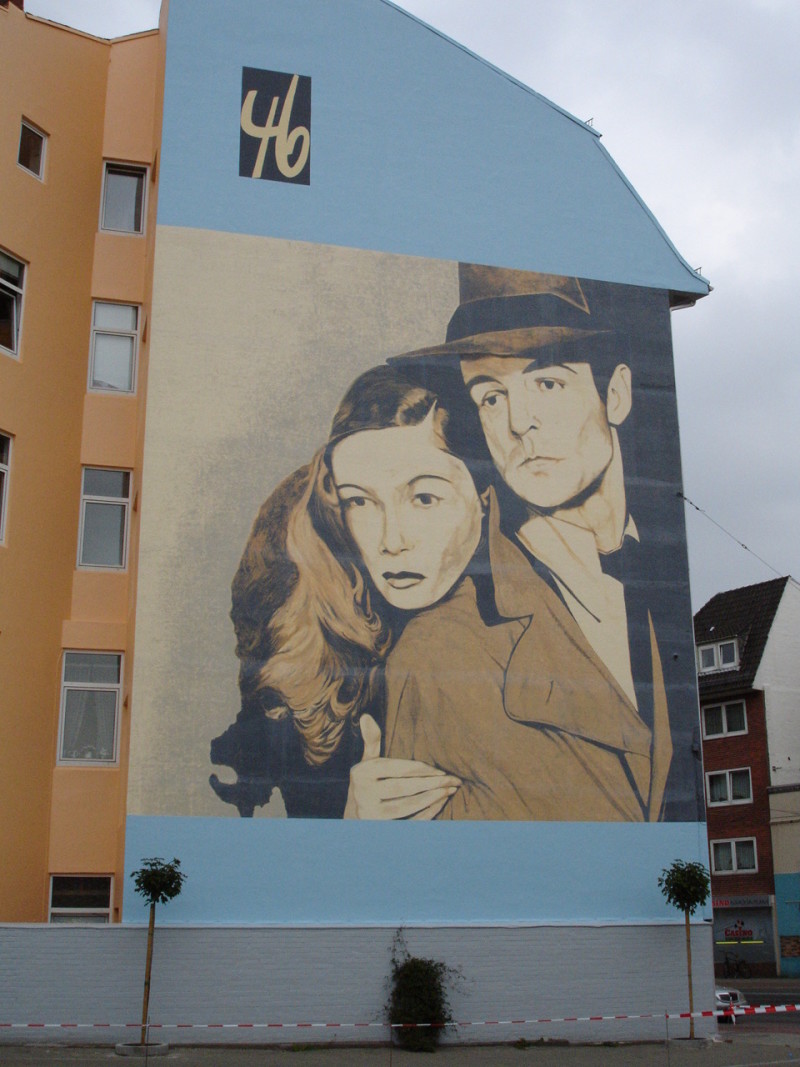 Wall painting opposite of the former space of cinema city 64  (then "Kino 46") at the Heerstraße, in Walle/Bremen. It shows a still of Veronica Lake and Alan Ladd from the movie "Die Narbenhand"