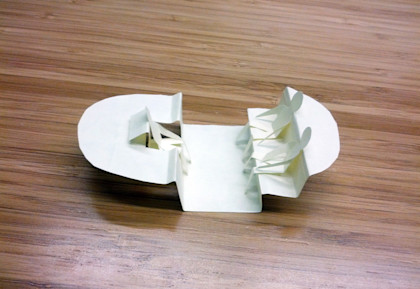 A photo of an early Firefly prototype made out of folded paper