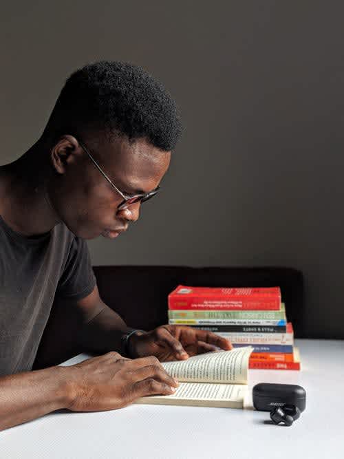 Image of a man reading books 