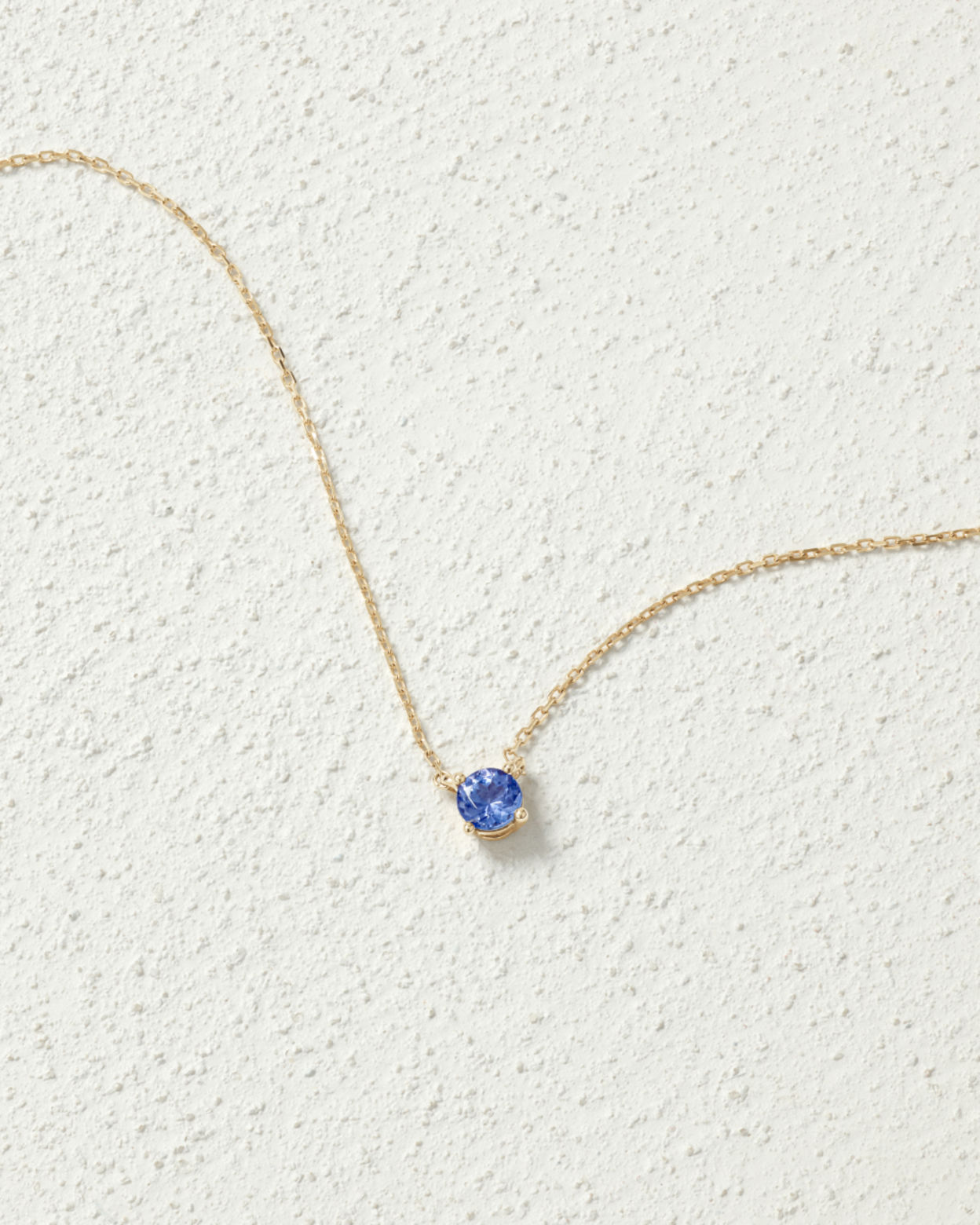 Flat lay of a tanzanite pendant