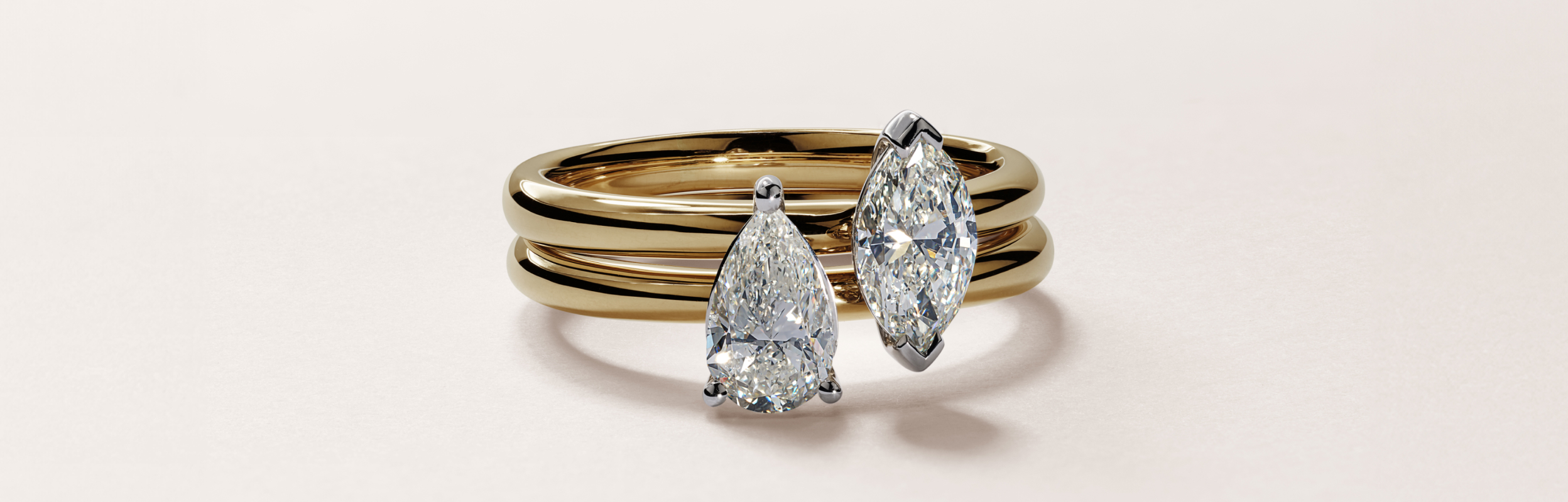 a pear and a marquise cute solitaire engagement ring both in yellow gold