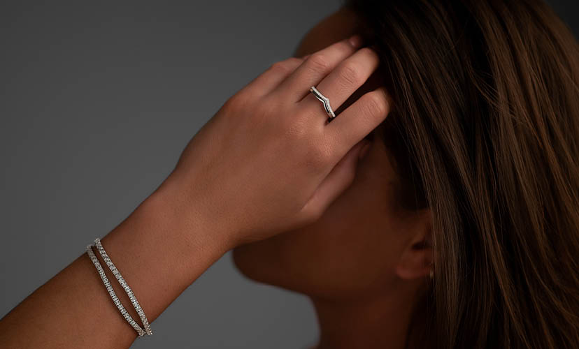 girl wearing diamond bracelets and rings