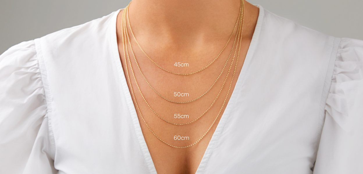 Close up of a female chest with four different lengths of chains: 45cm, 50cm , 55cm and 60cm