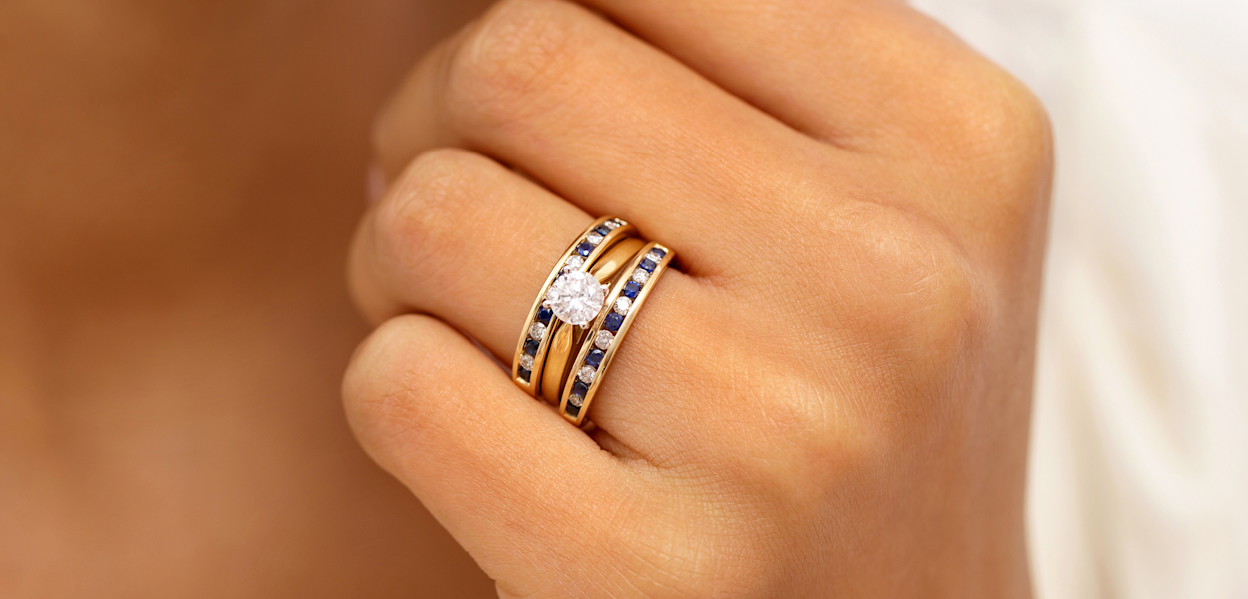 Close up solitaire engagement rings and gemstone wedding bands
