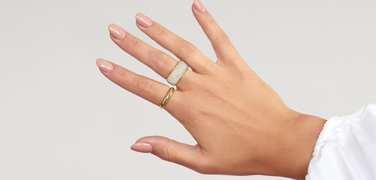 Female hand with statement diamond ring and yellow gold dome ring