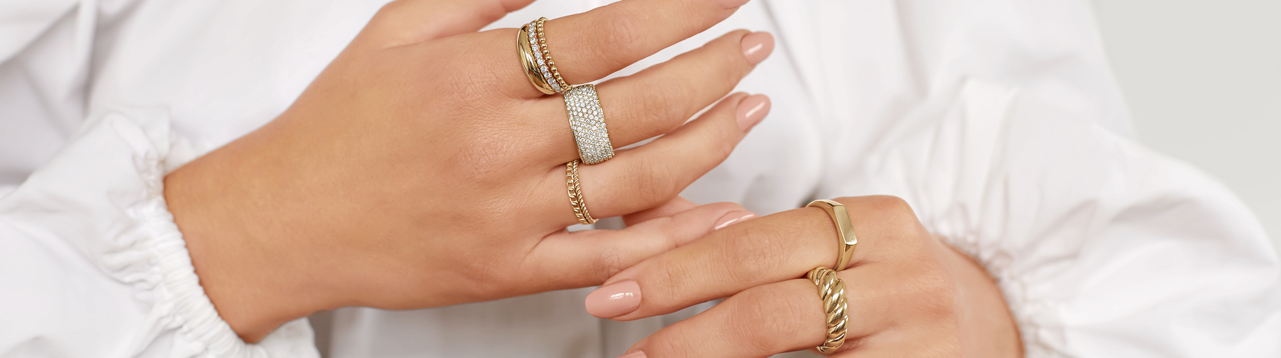 Gold Rings with Diamonds on Woman's hand