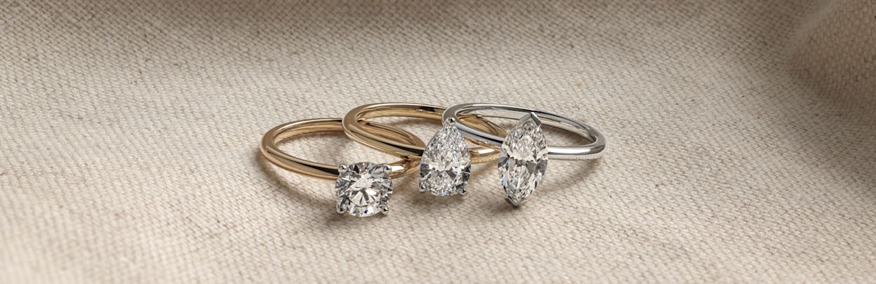 oval and pear cut three stone engagement rings in white gold