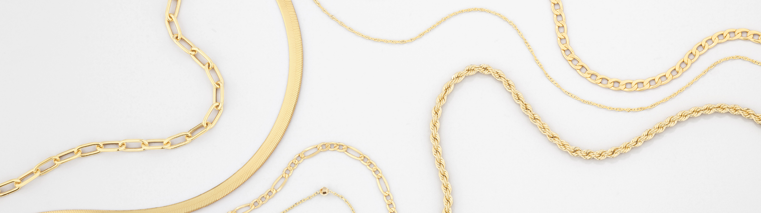 Flatlay of yellow gold chains