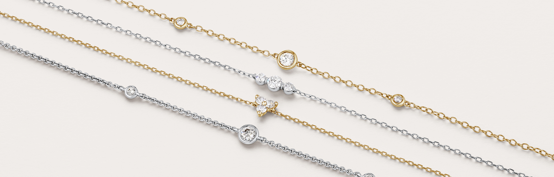 Women wearing layered necklaces and gold earrings and rings