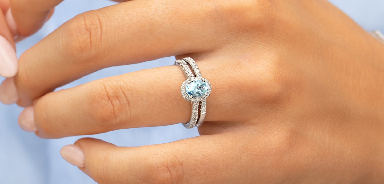 Close up of female hand wearing an Aquamarine bridal set