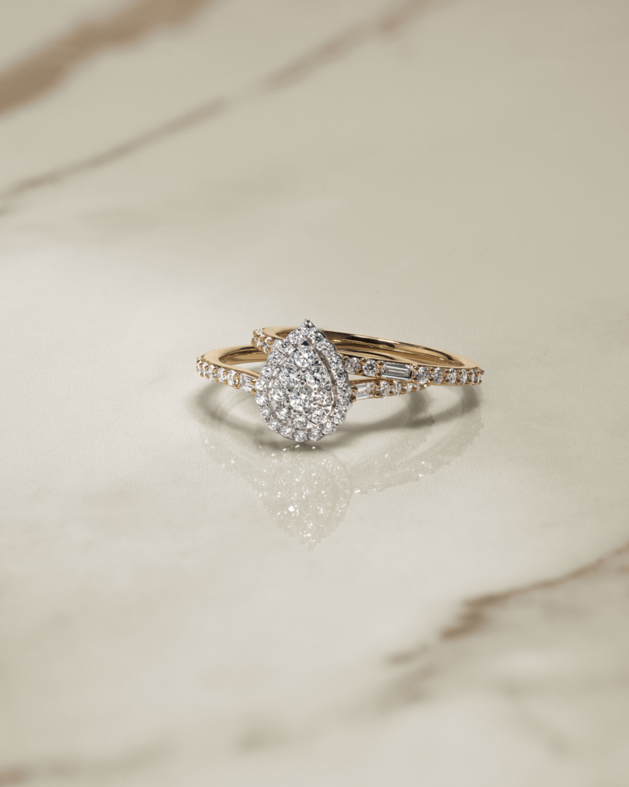 Flatlay of engagement ring and diamond wedding band