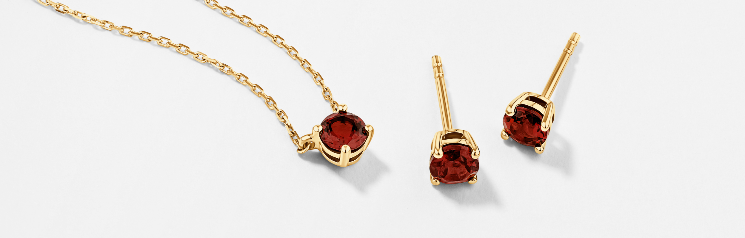 january birthstone jewellery with garnets in yellow gold