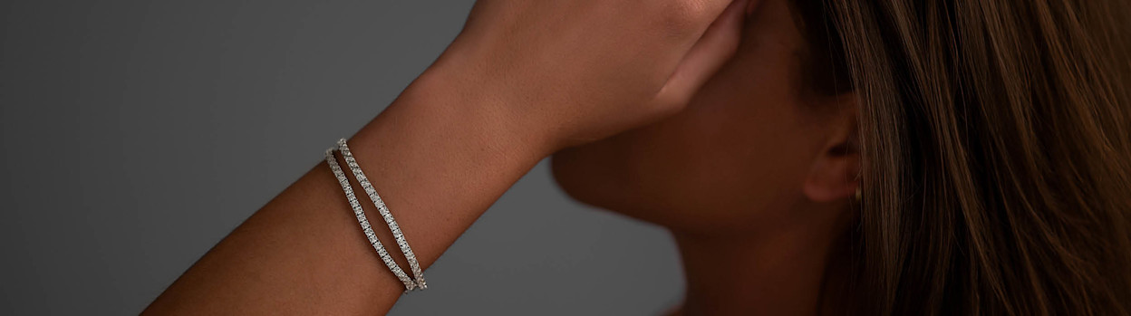 girl wearing diamond bracelets and rings
