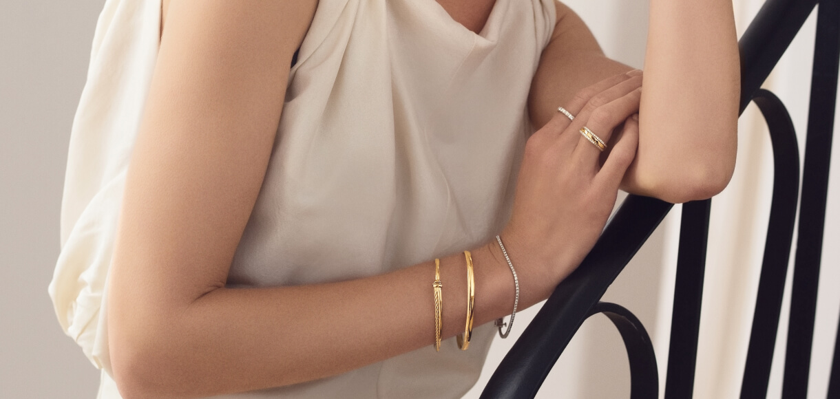 mix and matched gold bangles with diamond tennis bracelets