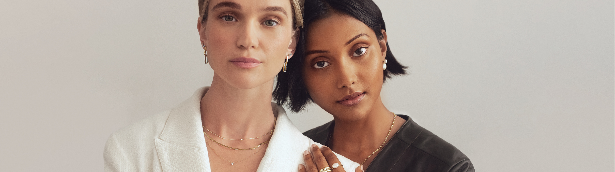 Two women wearing must-have jewellery essentials