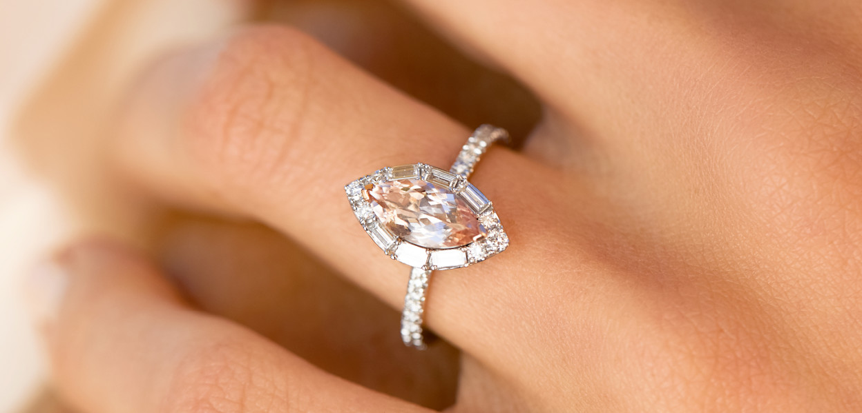 Close up of marquise cut morganite and diamond engagement ring