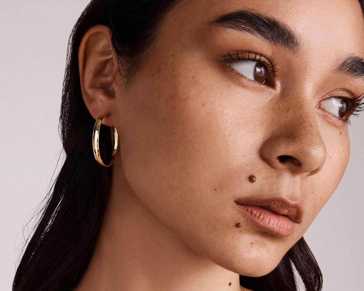model wearing gold hoops