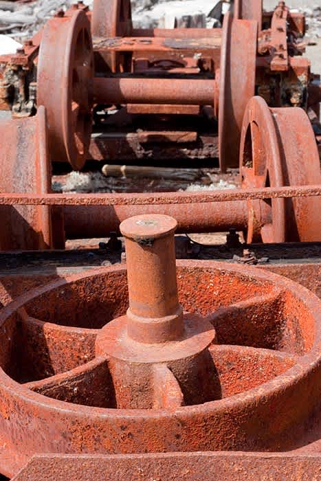 Photograph of old rusty narrow guage train wheels.