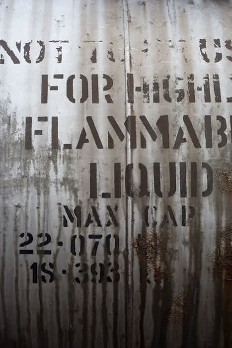 Photograph of old flammable liquid sign on railway tanker.