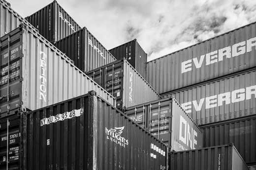 Black & White photograph of stacked cargo shipping containers.
