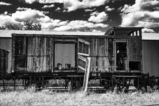 Black & White photograph of abandoned freight train carriage.