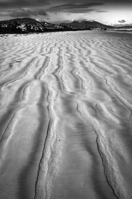 Photograph of the patterns left in the sand after the tide has gone out.