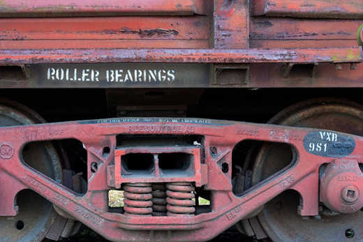 Photograph of old train carriage wheels.