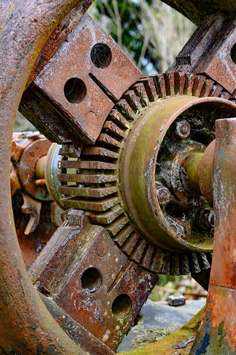 Photograph of corroded old machinery (part of a water wheel).