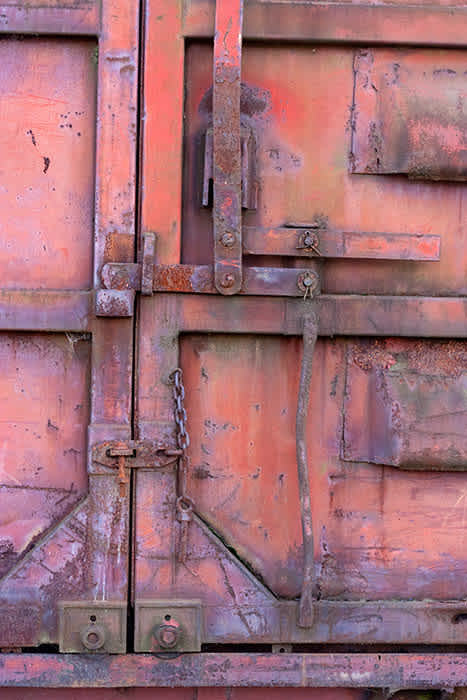 Photograph of door locking mechanism of old train carriage.