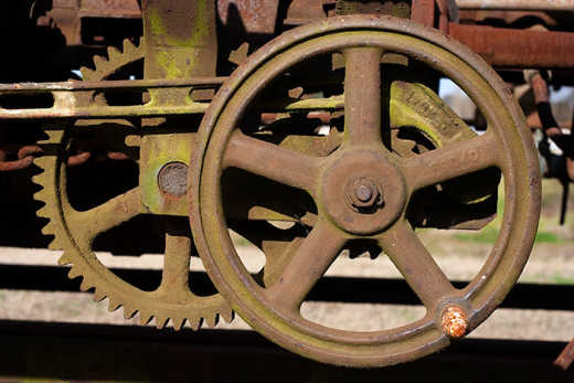 Photograph of winding wheel mechanism of old train carriage.