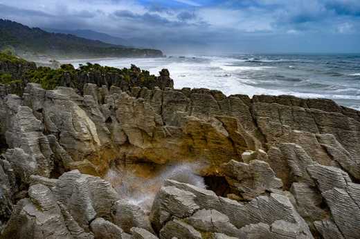 Photograph of Pancake Rocks blow hole in action.