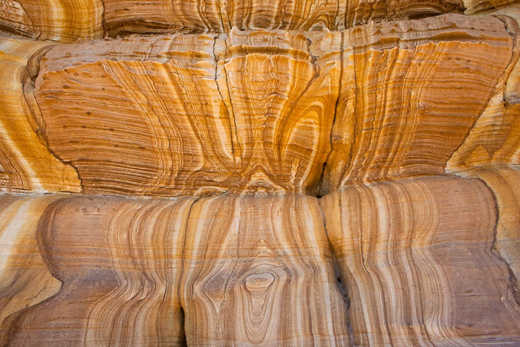 Photograph of colored rocks resembling a wave.