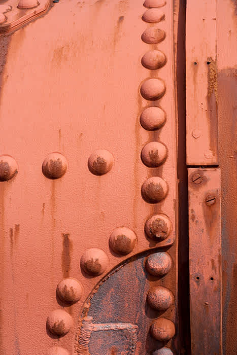 Photograph of old corroded steam train boiler.