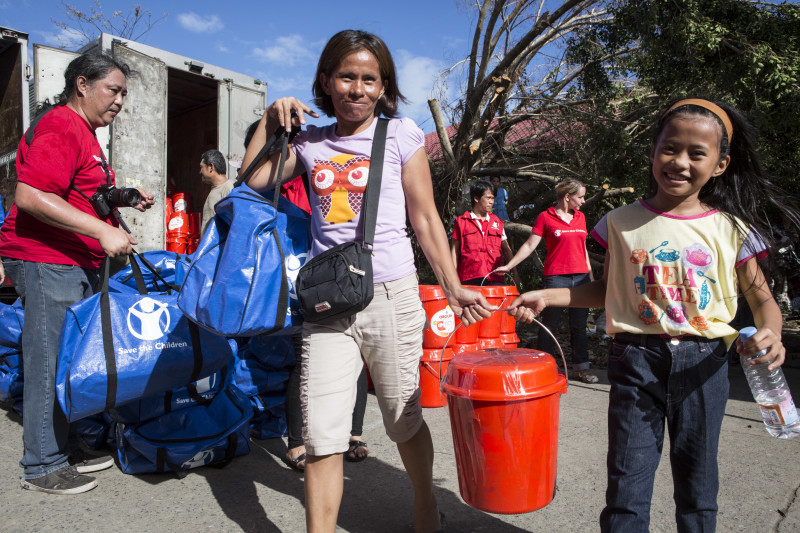 Beneficiaries with supplies from Save the Children.