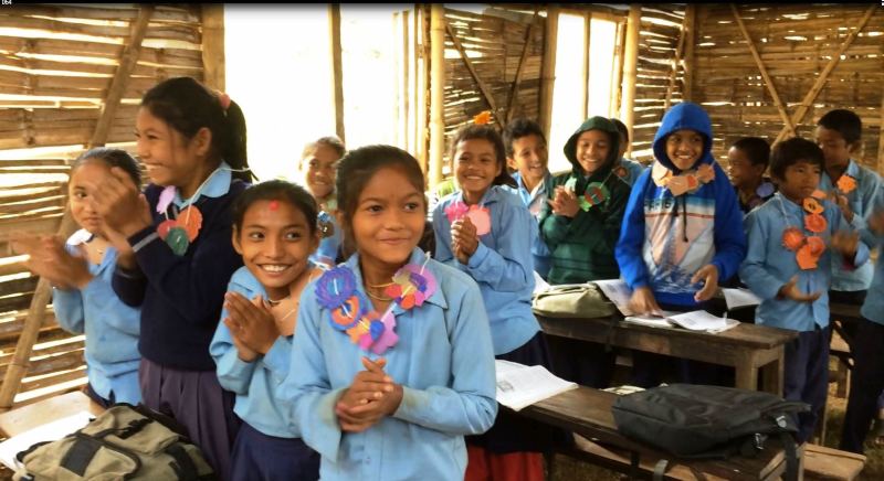 Students in Nepal receiving paper flower garlands made during the Challenge and delivered by Save the Children!