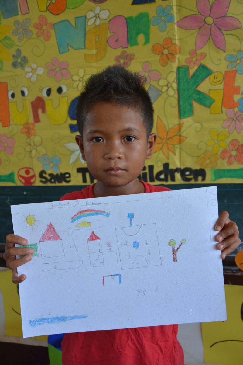 Filipino student with a letter delivered by Save the Children.