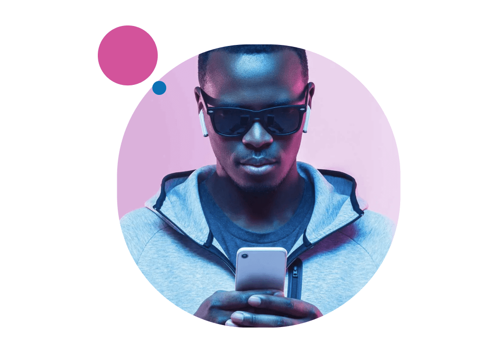 Round framed picture of a man with sunglasses and smartphone on pink background