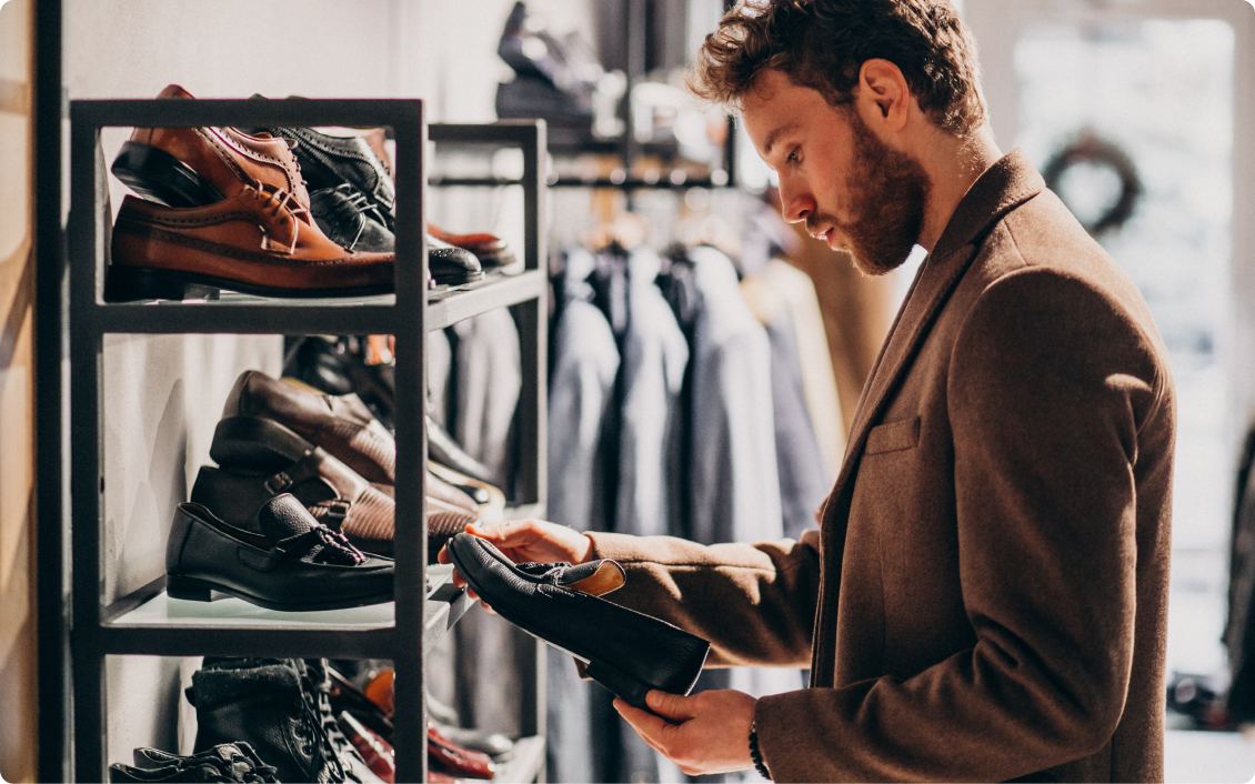 young man choosing shoes shop
