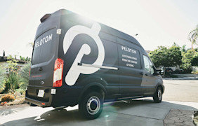 Peloton delivery van parked in a residential driveway