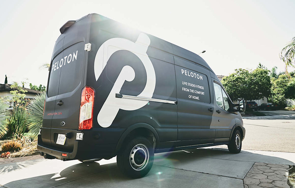 Peloton delivery van parked in a residential driveway