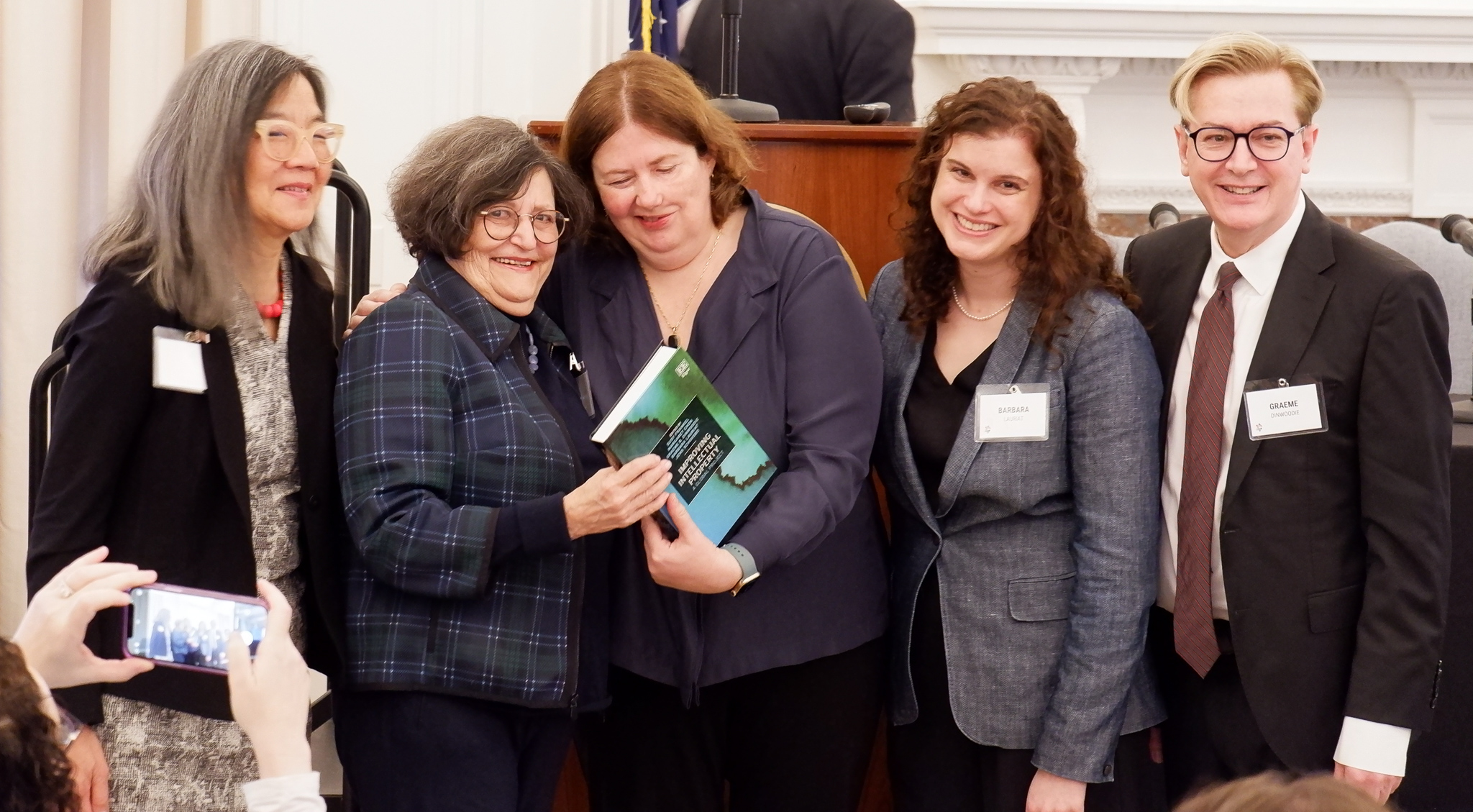 Professors Margaret Chon, Susy Frankel, Barbara Lauriat. and Graeme B. Dinwoodie present Professor Dreyfuss with the book Improving Intellectual Property