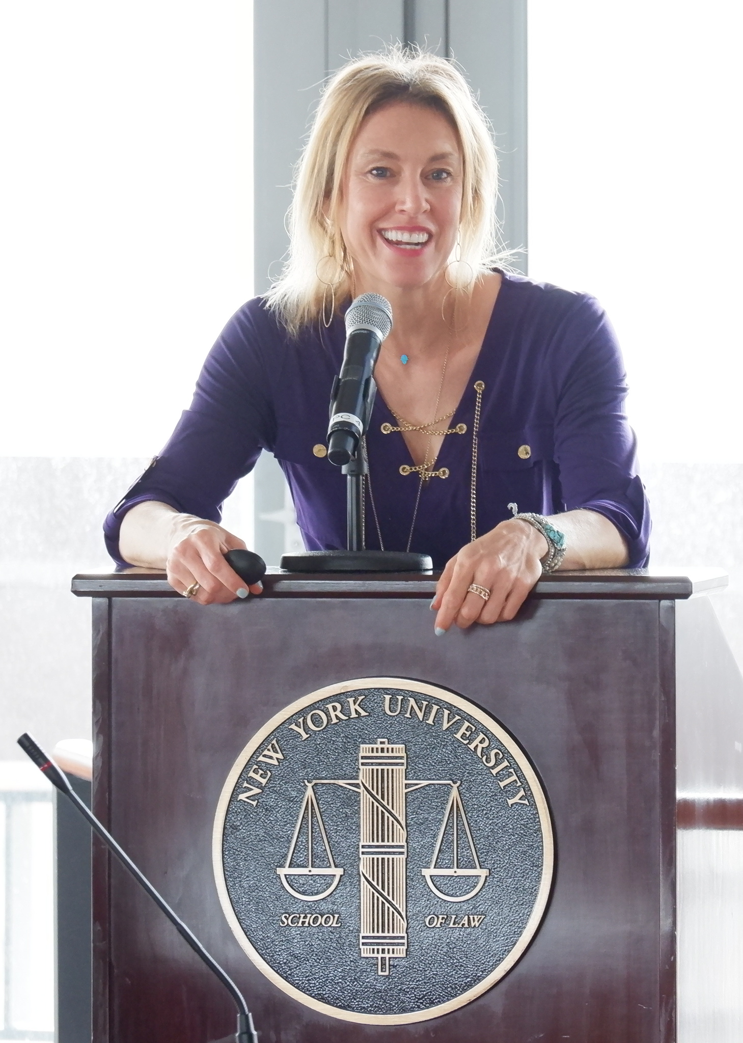 Professor Orly Lobel behind the podium with an NYU seal
