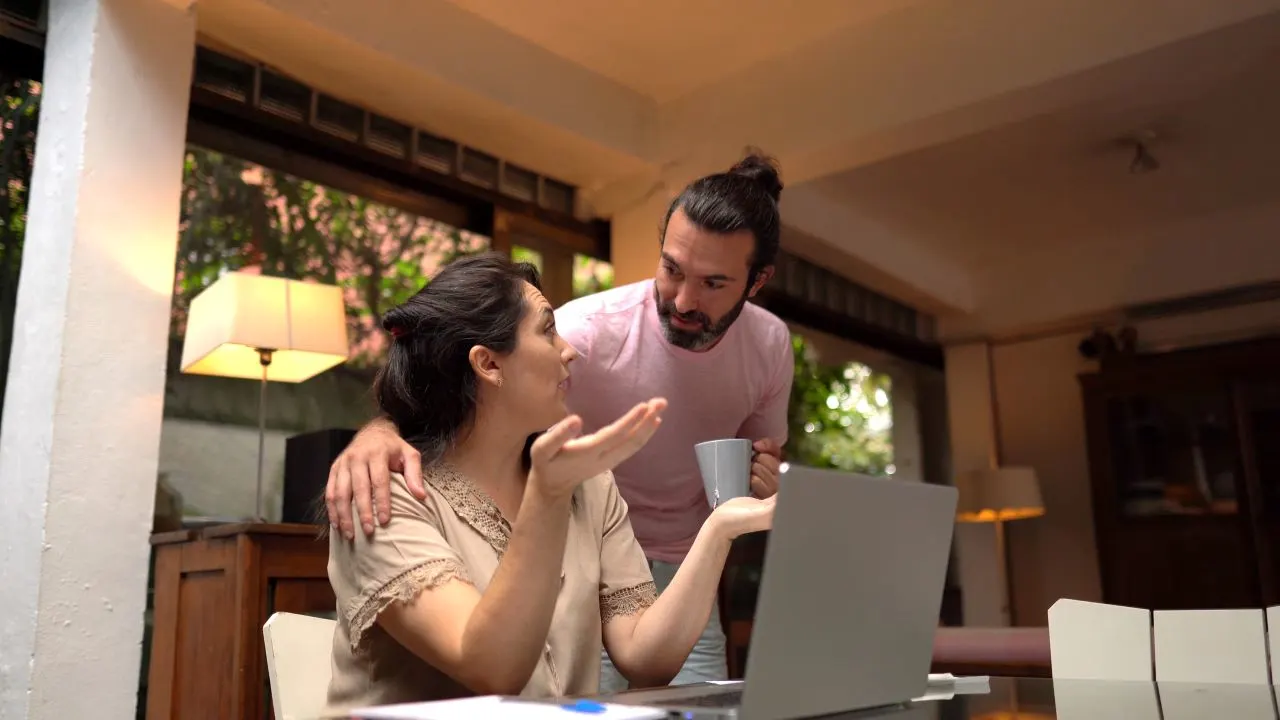 Worried couple having problems with their financial bills at home.