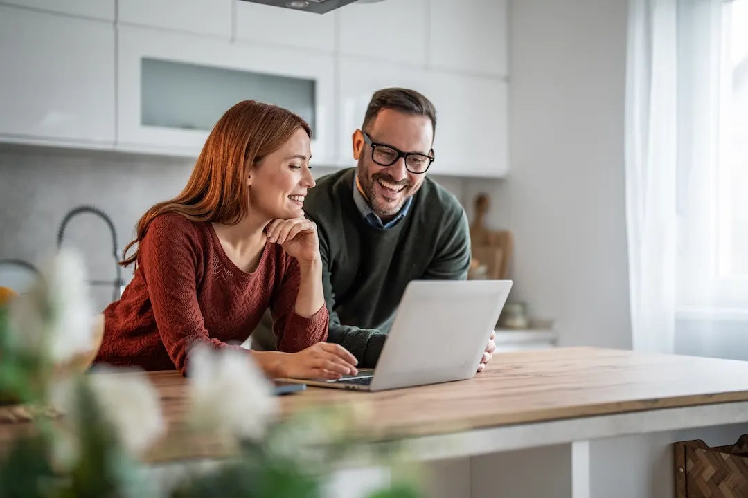 Couple checking out HELOC options on a laptop.