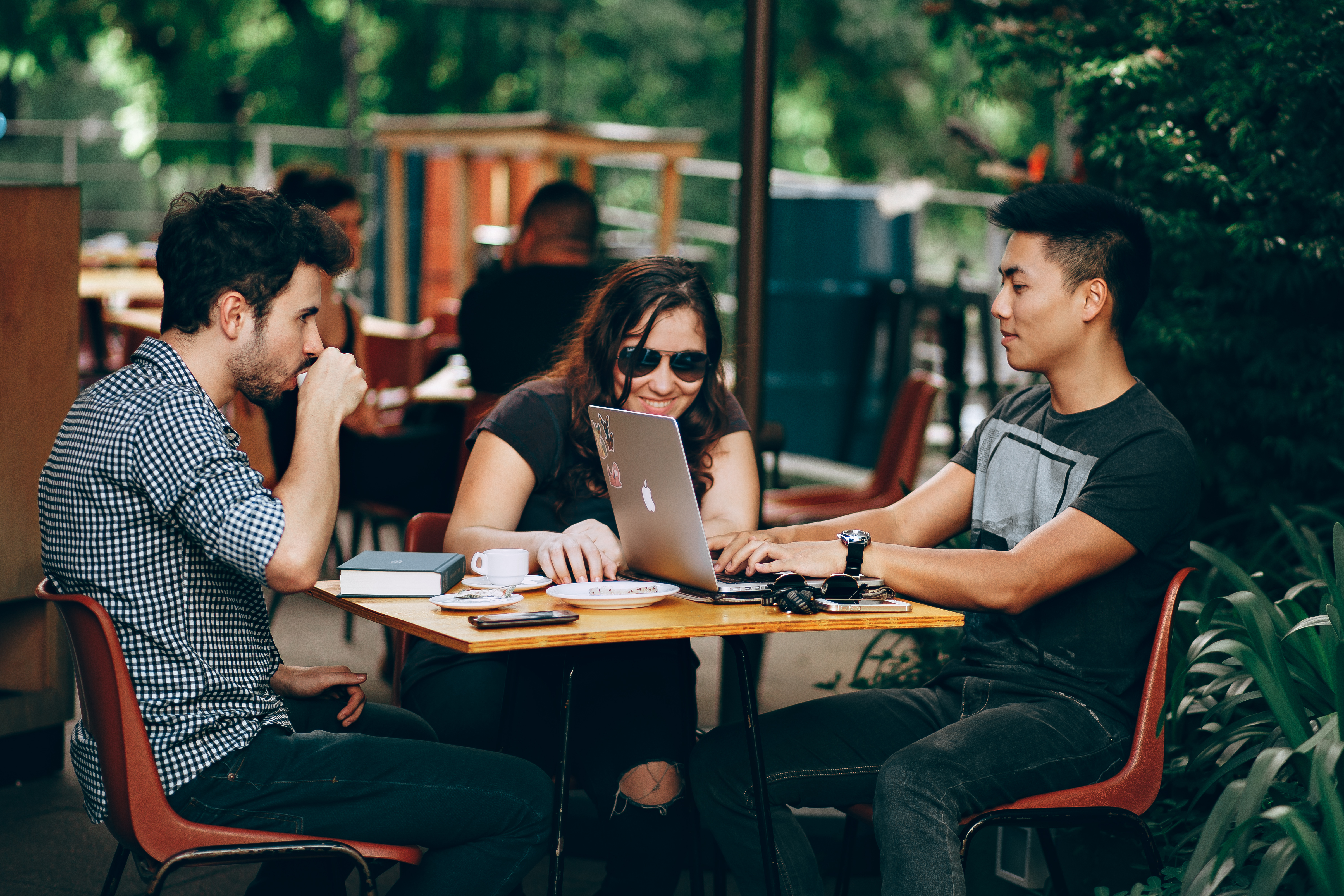 Friends hanging out at coffee shop with technology