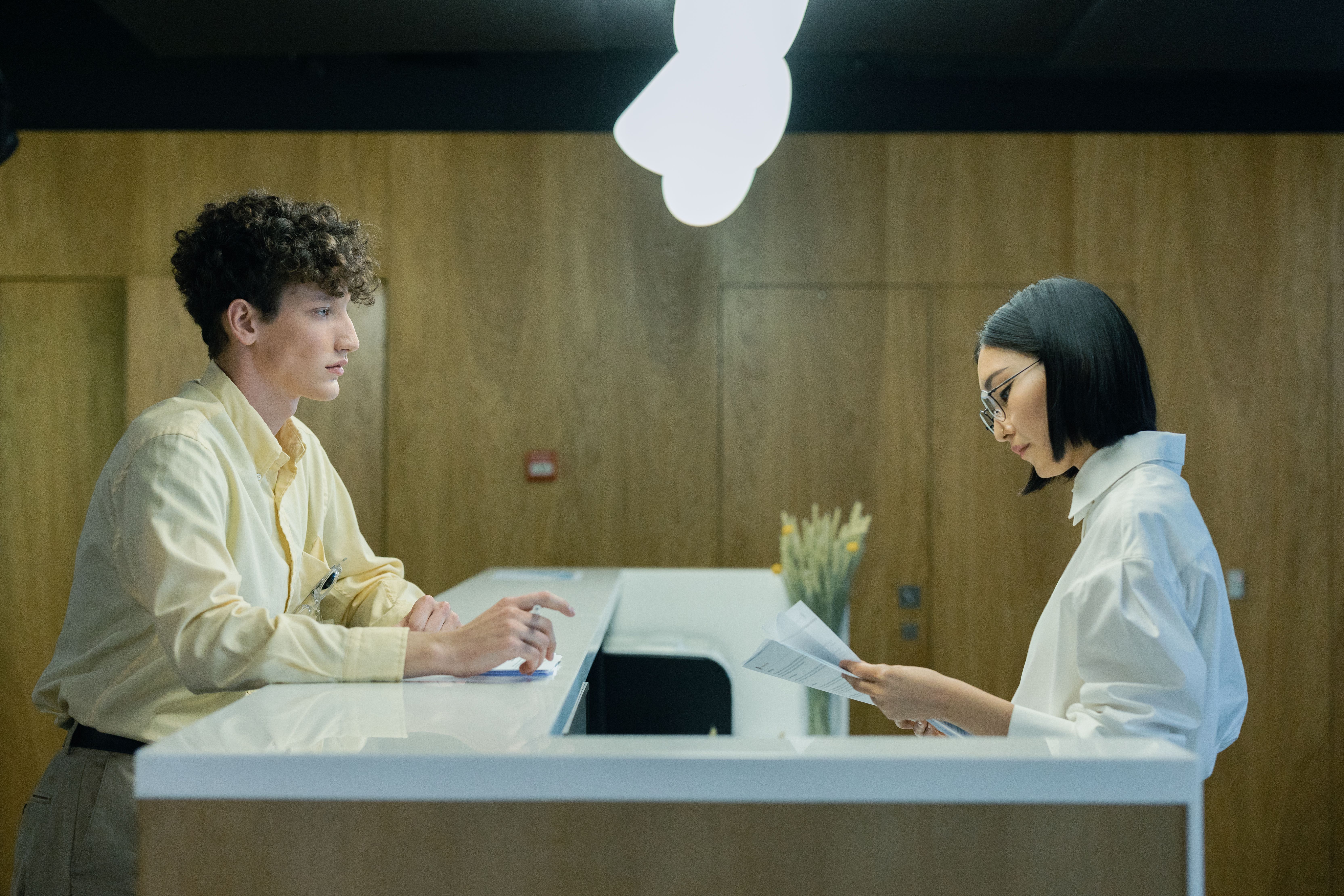 A salon owner at the reception desk