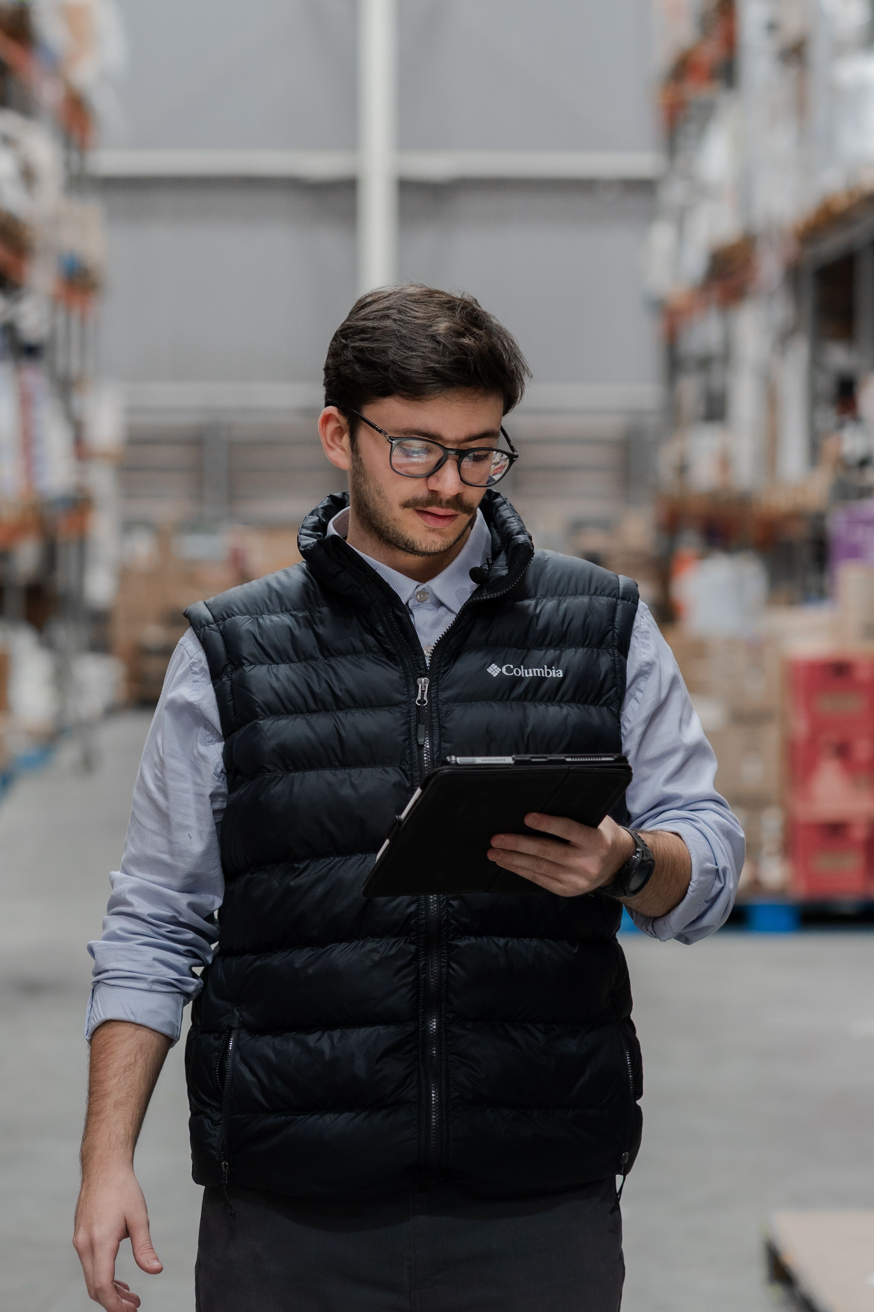 A warehouse worker checking stock on a tablet